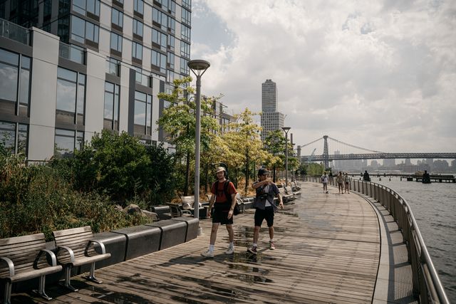 Pedestrians enjoy the Brooklyn waterfront.